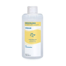 A 500 ml Dr. Schumacher GmbH DESCOLIND COMFORT LIGHT CREAM for sensitive skin, with a yellow-white label and a blue hand cream symbol.