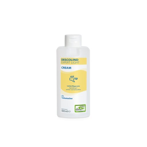 White 500 ml bottle of Dr. Schumacher DESCOLIND EXPERT LIGHT CREAM hand cream by Dr. Schumacher GmbH, with a yellow label containing product information in German, green logo at the bottom right, and the note for sensitive skin care.