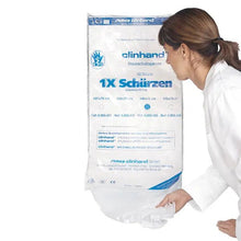 A woman in a white coat pulls a Clinhand women's disposable apron, 120 cm, from an Altruan package labeled "50 pieces" disposable aprons with product information in blue and black on the front.