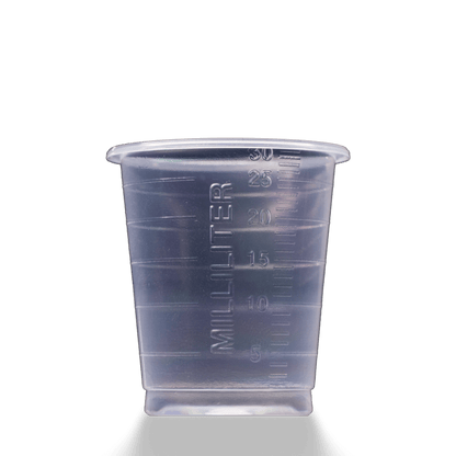 A MED COMFORT ECO disposable medical cup 30 ml graduated by AMPri Handelsgesellschaft mbH, with 5-30 mL milliliter markings, stands on a simple light surface.