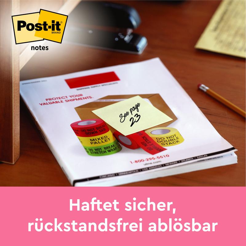 A yellow Post-it® note (38x51 mm) with the inscription "See page 23" lies on a desk, Post-it logo top left. Text below: "Sticks securely, removable without residue." 100 sheets/block, 16+4 free, from 3M Deutschland GmbH, 100% PEFC.