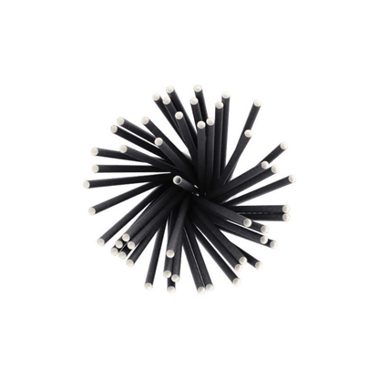 A top view of a group of eco-friendly, black cylindrical rods with white ends, arranged like sustainable shake straws, paper drinking straws Ø 8 mm, 25 cm, from PAPSTAR GmbH in a radial star pattern.