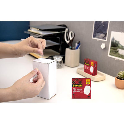 A person seals a white box with office supplies with Scotch® Super-Hold Secure Tape, 1 roll, 19 mm x 25.4 m from 3M Deutschland GmbH. The tape packaging is inserted in the lower right corner.