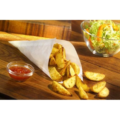 Potato wedges in a PAPSTAR 1000 cone bag, parchment substitute, greaseproof from PAPSTAR GmbH served on a wooden board, with a glass bowl of red dip sauce and a green salad with orange peppers in the background.