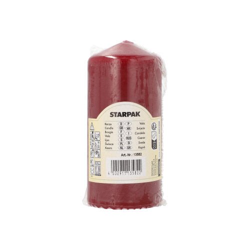 A red Starpak pillar candle (Ø 60 mm, 130 mm) with extra long burning time is packaged in transparent plastic and provided with a beige label with brand name, product details, barcode, and safety symbols for long use.