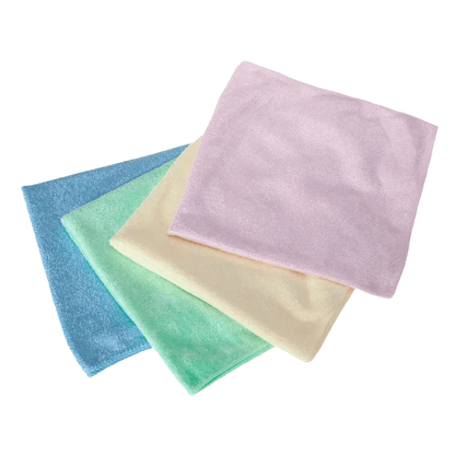 Four AMPri Clean Comfort microfiber cloths, elegantly presented in the pastel shades of blue, green, yellow, and pink by AMPri Handelsgesellschaft mbH, are artfully arranged on a flawlessly white background.