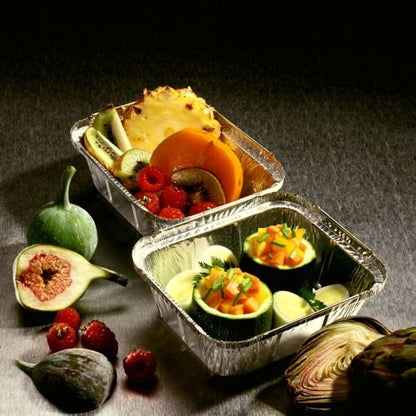 Two Starpak 10 trays, aluminum + insert lid, PP-coated rectangular trays present fresh pineapple, kiwi, raspberries, figs, pumpkin, and zucchini on a dark surface with whole figs and an artichoke beside - ideal for food storage.