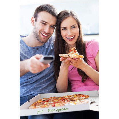 A man and a woman smile on a sofa with pizza from a PAPSTAR 100 pizza boxes, cellulose "pure" square box from PAPSTAR GmbH; on the eco-friendly box made of pure cellulose it says "pure Buon Apetito!" while he holds a remote control.