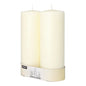Two unlit Starpak 2 pillar candles Ø 80 mm with flat top stand side by side, wrapped at the base with a labeled band, exuding timeless elegance.