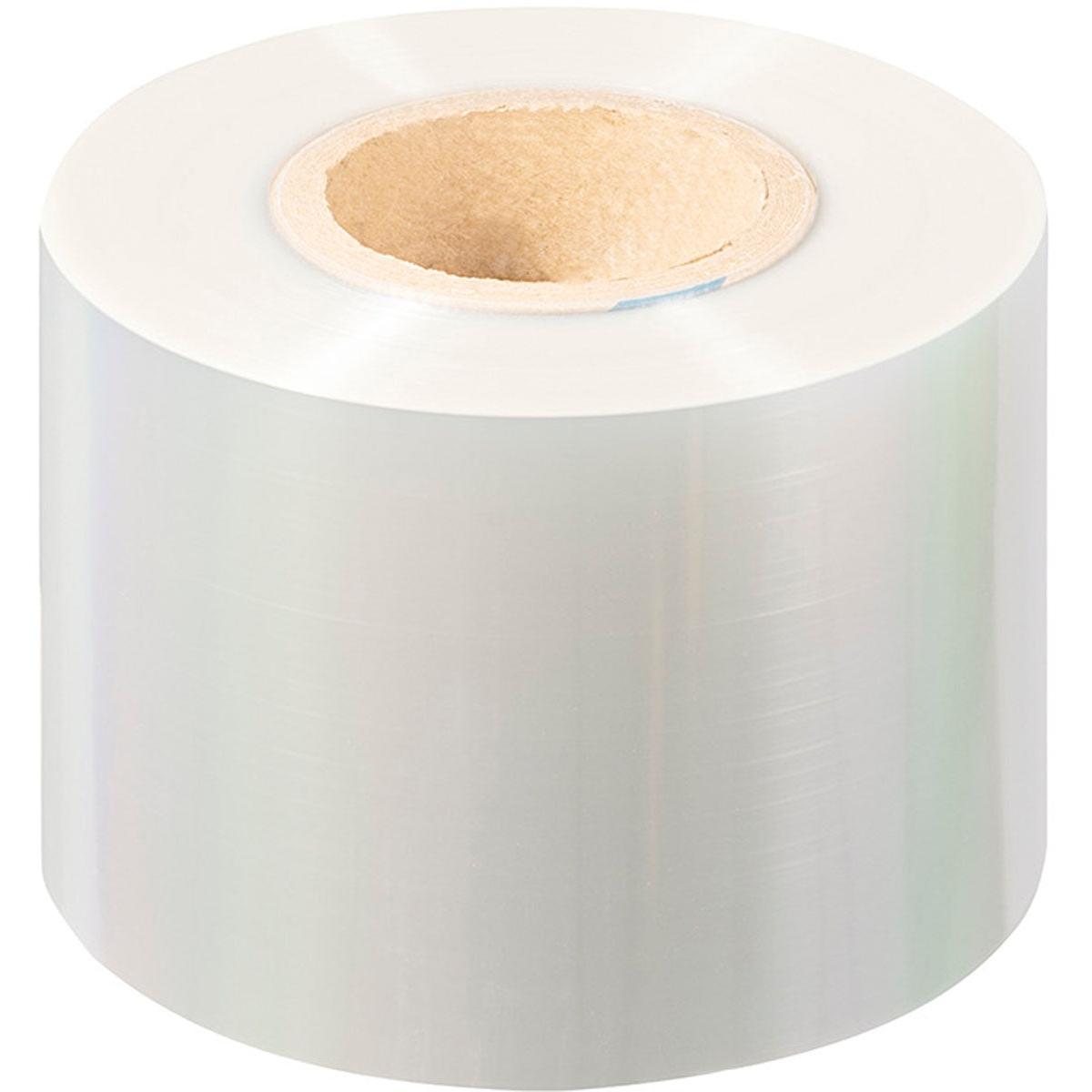 A large roll of clear, glossy PET sealing film Antifog PET from Duni GmbH with a cardboard core stands upright on a white background. The transparent film is fog-free and ensures optimal clarity for demanding packaging applications.