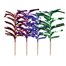 Four metallic foil palm cupcake toppers in the colors red, purple, blue, and green by PAPSTAR 144 assorted color decoration picks by PAPSTAR GmbH are attached to wooden toothpicks and arranged in a row on a white background.