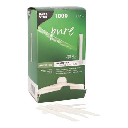 A green box from PAPSTAR GmbH with the label "Toothpick pure" (1000 pieces, round, wood, 6.5 cm) is partially open, revealing environmentally friendly toothpicks, in front of which several hygienically packaged pieces lie.
