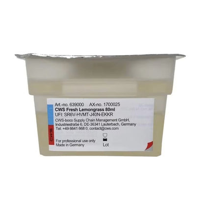 A sealed plastic container labeled "CWS ParadiseLine Washroom Fragrance for Fragrance Dispenser Paradise Air Bar" by CWS, with a foil lid and contact label, intended for professional use of washroom fragrance only.