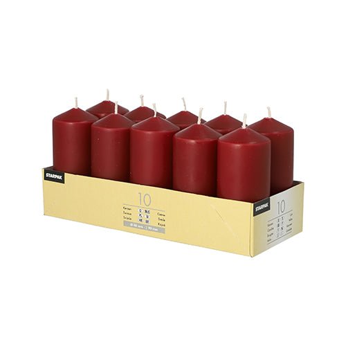 A cardboard tray holds 10 Starpak pillar candles (Ø 40 mm, 90 mm) in two rows. Each red candle has a white wick – ideal for weddings or celebrations. The tray features a side label with product details.
