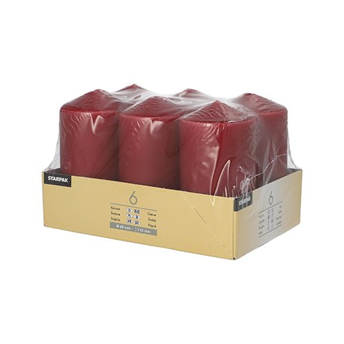 A package of six Starpak pillar candles (Ø 60 mm · 115 mm), wrapped in clear plastic and placed in a labeled cardboard holder with product details on the side.
