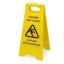 A yellow Nölle Profi Brush warning sign "Caution Wet Floor" (30x63 cm, double-sided) from Nölle Profi Brush Bürsten- & Pinseltechnik e.K. with black lettering and a slipping person symbol stands open on the floor.