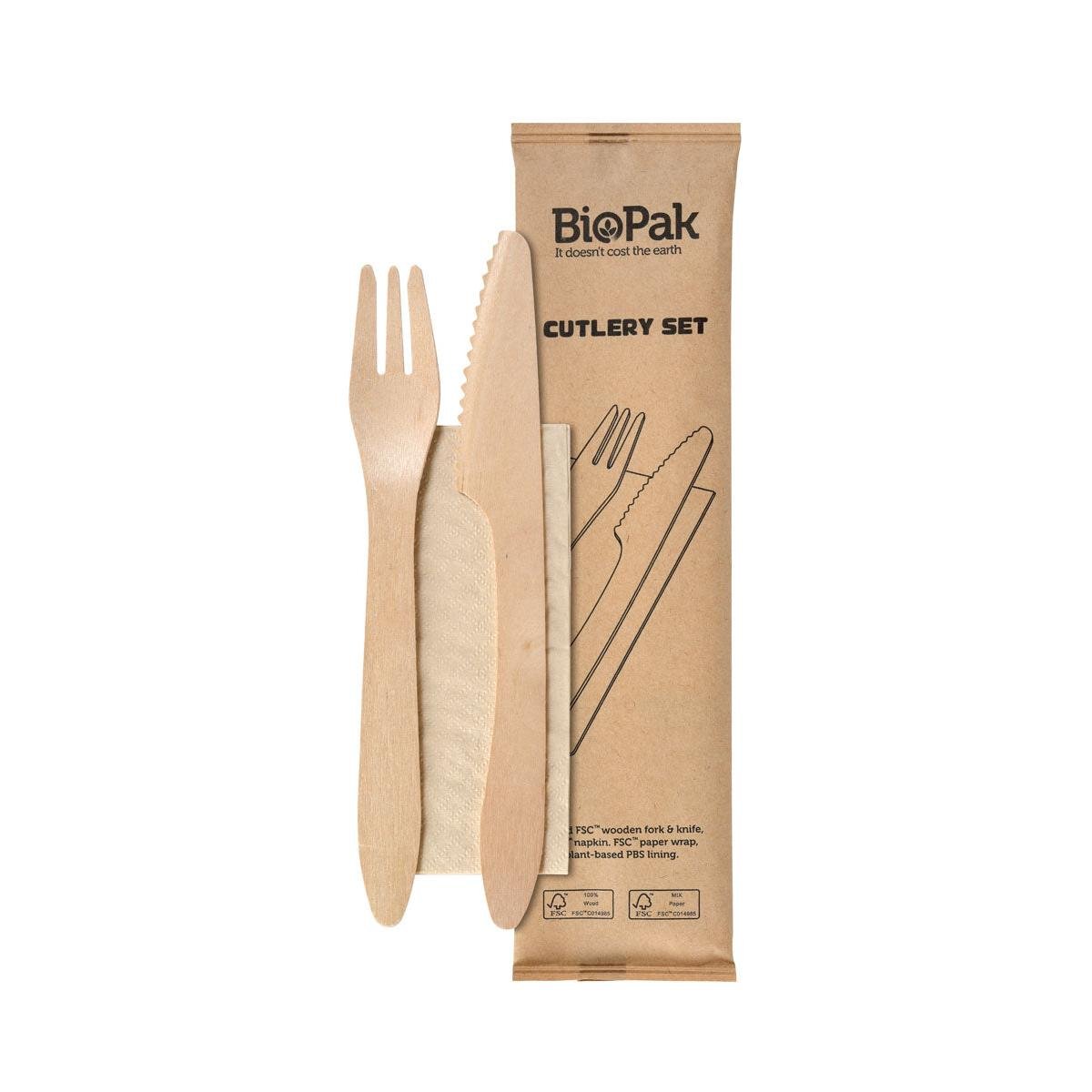Wooden fork and knife and a brown napkin from the 3/1 cutlery set by Duni GmbH are together; the 250-pack is made of naturally waxed wood and features eco-symbols that emphasize the sustainable design.