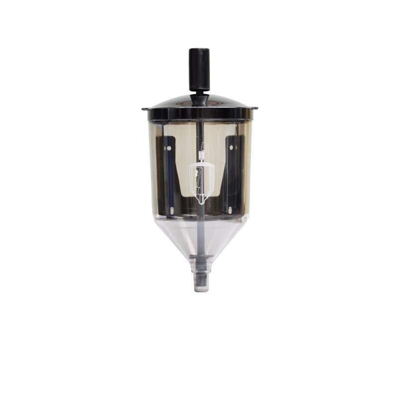 The Reinol paste dispenser from Diversey Deutschland GmbH & Co. OHG is a transparent plastic dispenser with a black lid and handle, white central mechanism, and conical spout, ideal for Reinol S hand washing pastes. Package: 1 piece. Pictured on a white background.