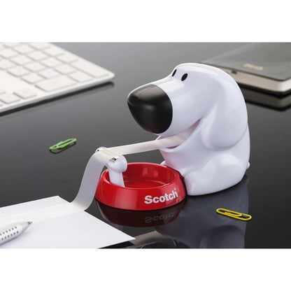 The Scotch™ desktop dispenser in dog design C31 with Scotch® Magic™ invisible tape (19 mm x 8.89 m, 1 roll/package) by 3M Deutschland GmbH sits on a black desk next to a keyboard, notebook, and colorful office supplies.