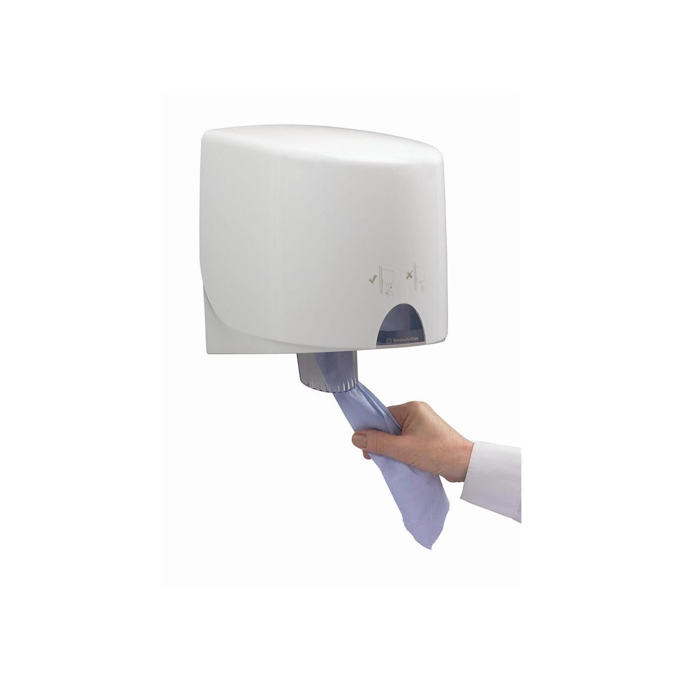 A hand pulls a blue paper towel from the white Aquarius™ towel dispenser - central dispensing by Kimberly-Clark GmbH, a wall-mounted dispenser that ensures hygienic removal.