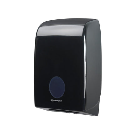 The black Aquarius™ dispenser for folded towels (Interfold) by Kimberly-Clark GmbH features a round front opening and a logo underneath and is designed for wall mounting. 1 dispenser per box, depicted on a white background.