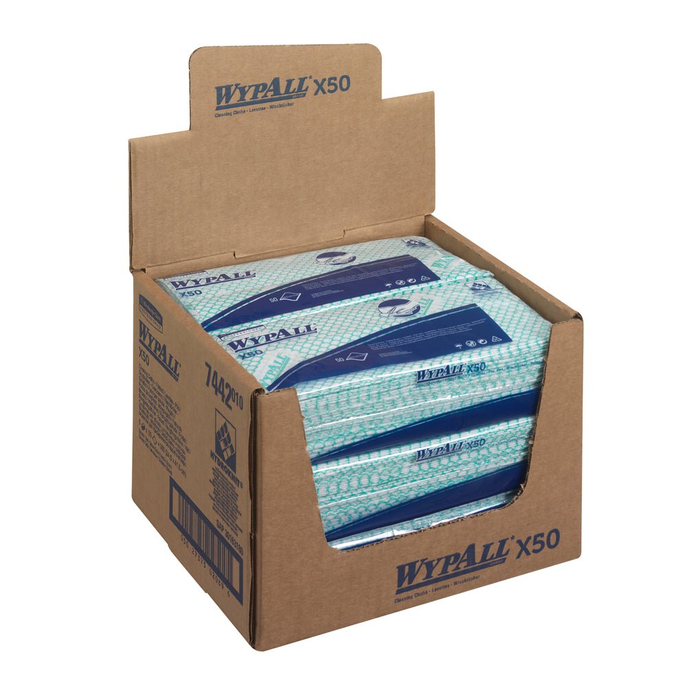 A dispenser carton from Kimberly-Clark GmbH contains 6 bags of WypAll® X50 Critical Clean Interfold Green cloths (50 sheets each); multiple packs are visible, and the carton shows product details and branding for professional cleaning.