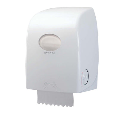 The white, wall-mounted Scott® ESSENTIAL™ towel dispenser from Kimberly-Clark GmbH features a transparent window showing the roll's contents, a protruding sheet, and an illustrated pull symbol for easy handling.