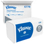 A Kleenex® White Folded Hand Towel (Large Pack) from Kimberly-Clark GmbH is displayed in front of a branded shipping carton; both contain 15 packs of 124 sheets each (15 packs per carton), for a total of 1,860 hand towels.