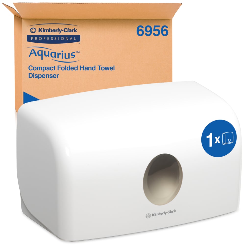 A white Aquarius™ dispenser for folded towels from Kimberly-Clark GmbH (MultiFold, Small) stands in front of its brown packaging. The compact container ensures hygienic paper removal through the round opening at the front.