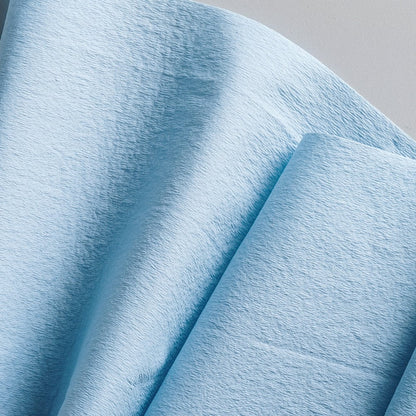 A close-up of WypAll® L20 paper wipe in blue from Kimberly-Clark GmbH, large roll with 500 sheets and folded for easy access - perfectly suited for maintenance work, presented against a neutral background.