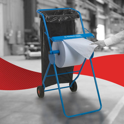 A person uses a WypAll® L30 paper wipe from Kimberly-Clark GmbH from the extra-wide large roll on a blue dispenser with a trash bag in an industrial setting - perfect for industrial cleaning tasks.