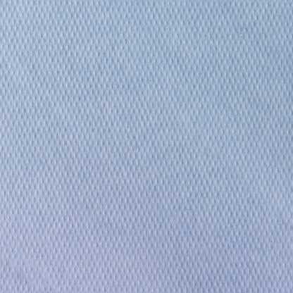 Close-up of Scott® doctor's rolls from Kimberly-Clark GmbH (38.00 cm x 51.00 cm), a light blue, textured fabric with a subtle diamond pattern, commonly used for examination couches in medical facilities. The smooth surface fills the frame.