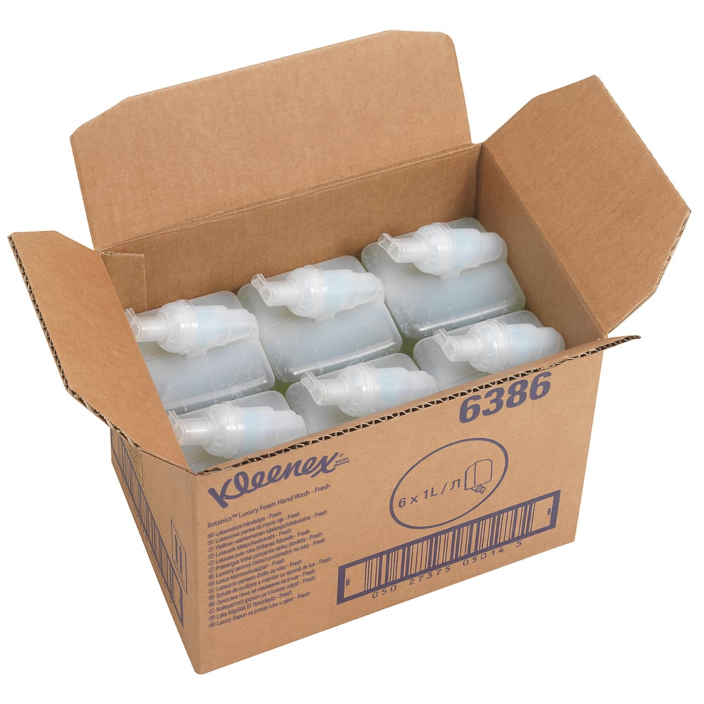 An open box labeled "Kleenex® Botanics™ Luxury Foam Hand Wash - 1L Cartridge" from Kimberly-Clark GmbH contains six green 1L cartridges, information, and a barcode. The box highlights foam soap with botanical extracts.