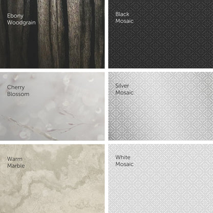 A grid of six pattern surfaces for the Kimberly-Clark Professional™ Icon™ toilet paper dispenser - small rolls from Kimberly-Clark GmbH: Ebony Woodgrain, Black Mosaic, Cherry Blossom, Silver Mosaic, Warm Marble, and White Mosaic - each in muted tones.
