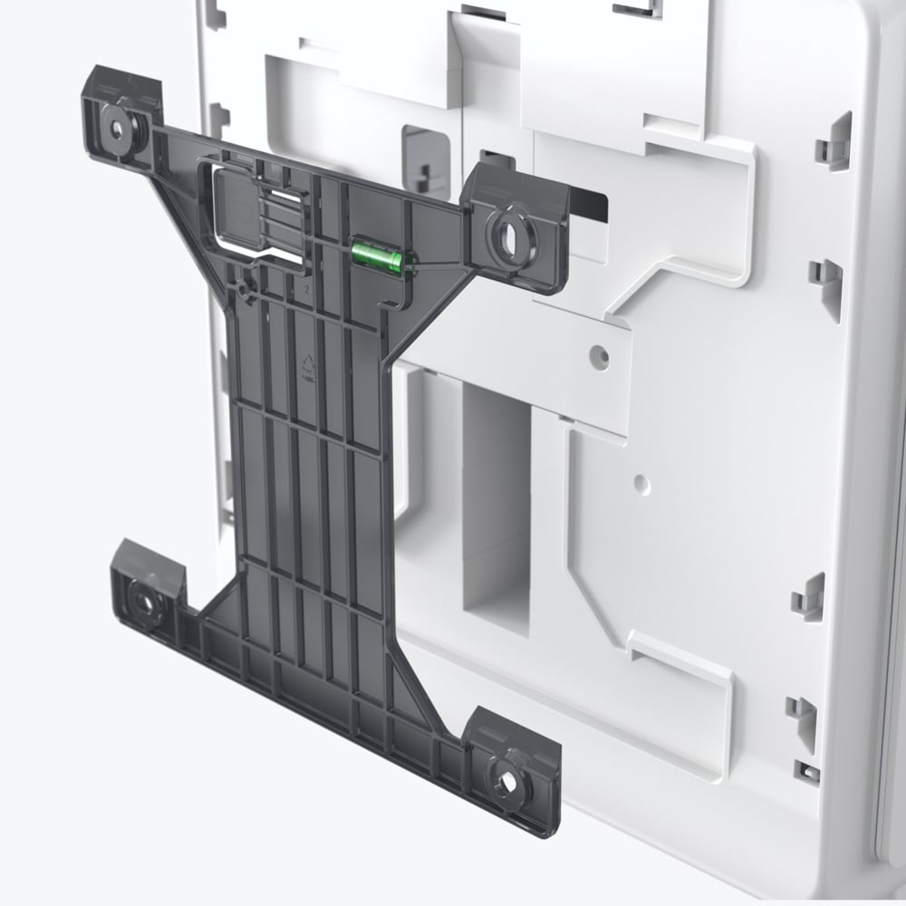 On the back of the Kimberly-Clark Professional™ Icon™ Electronic Hand Towel Dispenser in White, there is a black plastic bracket with an integrated spirit level, detailing the hygienic mounting system.