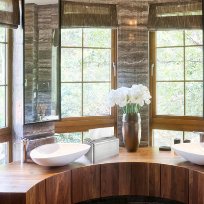 A modern bathroom with a wooden countertop, two white sinks, brown blinds, a vase with white flowers, and an elegant Kleenex® towel dispenser made of stainless steel by Kimberly-Clark GmbH with pull-box function next to the tissue box. Trees are visible outside.