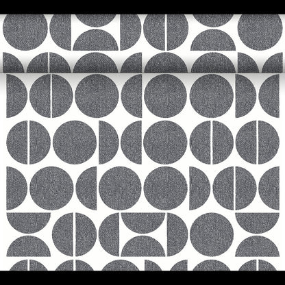 The Dunicel Tête-à-Tête table runner (24 m x 0.4 m, 20 sections) from Duni GmbH features black and white geometric patterns—full circles, semicircles, and segmented circles—ideal for a modern tête-à-tête table setting.