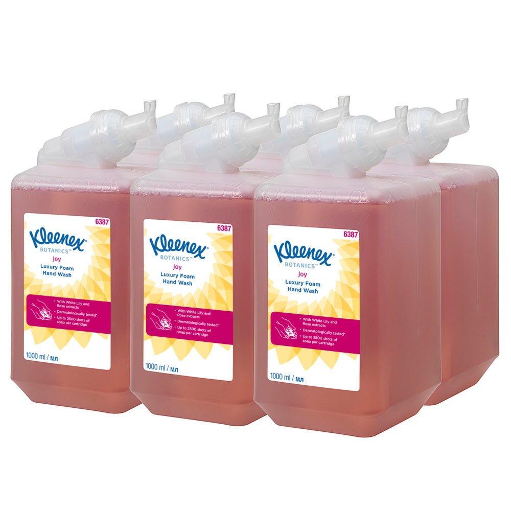 Six 1-liter cassettes of Kleenex® Botanics™ Luxury Foam Hand Wash from Kimberly-Clark GmbH, each filled with red liquid and plant-based ingredients, are neatly arranged in two rows of three. Each cartridge dispenses foam and is delivered in a box of six.