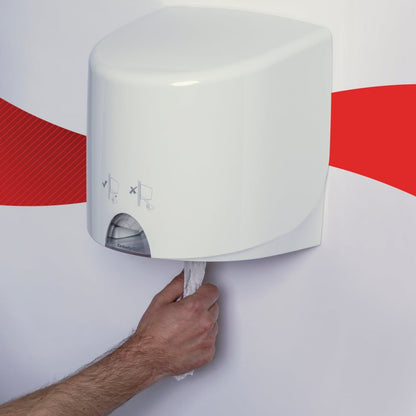 A person pulls a WypAll® L10 paper towel for food & hygiene from Kimberly-Clark GmbH from a white wall dispenser with a red stripe on the wall in the background.