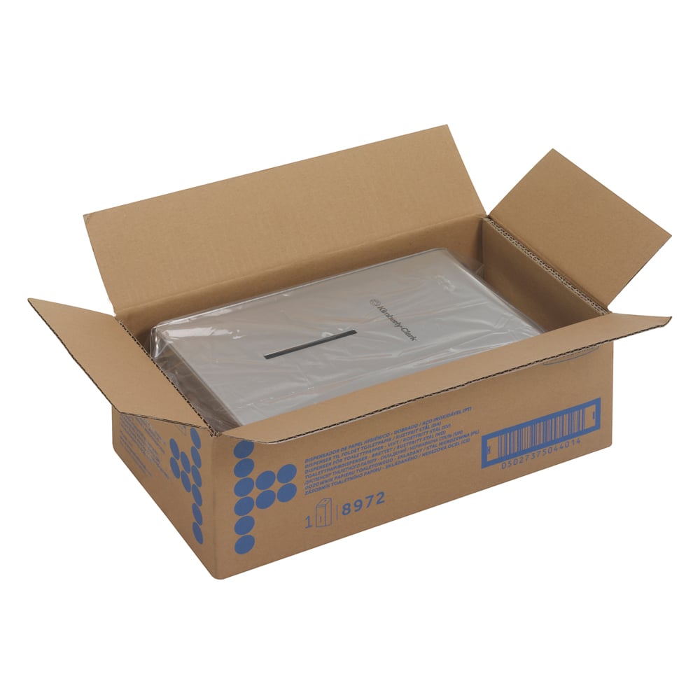 An open box with blue Kimberly-Clark GmbH graphics and a barcode contains a partially visible, clearly packaged Kimberly-Clark Professional™ stainless steel toilet paper dispenser - ideal for commercial washrooms.