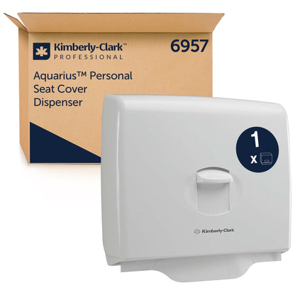 A Kimberly-Clark GmbH Aquarius™ toilet seat cover dispenser - White (1 dispenser) is displayed in front of its branded packaging with the number 6957 - ideal for hygiene in public toilets.