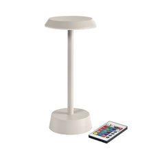 The NOUR LED wireless lamp taupe by Duni GmbH is a modern table lamp with a flat shade and round base, operated with a multifunction remote control - perfect for stylish table lighting.