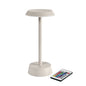 The NOUR LED Wireless Lamp in Taupe by Duni GmbH is a modern table lamp with a flat shade and round base that is controlled by a multifunction remote control—perfect for stylish table lighting.