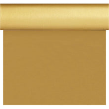 A roll of gold-colored wrapping paper is partially unrolled and reflects the smooth, shiny appearance and the uniform texture of the Dunisilk Tete a Tete 0.4x24m gold tablecloth from Duni GmbH.