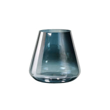A transparent, blue-tinted glass vase with a wide base and narrow opening against a white background highlights the elegance of the Duni GmbH candle holder Glass Etna 10.5x11.5 cm - an elegant table decoration holder.