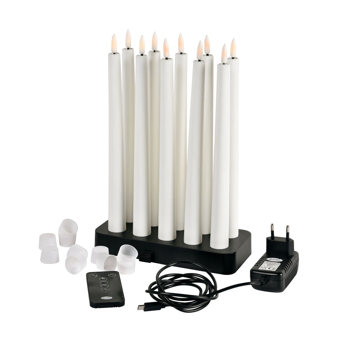 A pack of 1 Duni GmbH LED taper candles 27.8 cm in warm white is elegantly presented with a black charging station, remote control, plug adapter, USB cable, and white caps - perfect for stylish home decoration.