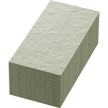 A stack of 33x33 cm large, 3-ply paper napkins in pistachio green by Duni GmbH, with a patterned edge on one side, viewed diagonally from above. The package contains 250 high-quality napkins.
