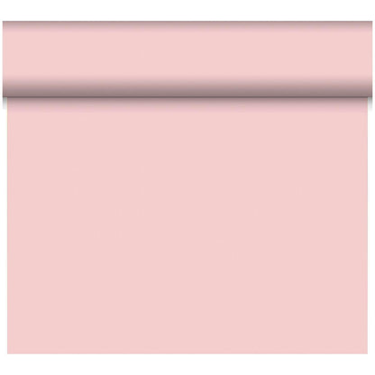 A roll of Duni GmbH Bio-DC-Tete a Tete 0.4x24m light pink wallpaper is partially unrolled, revealing its smooth, solid surface; the top part remains rolled while the rest hangs vertically.