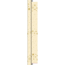 The Dunicel roll 25x1.18m Star Stargazing cream from Duni GmbH features a beige design with golden snowflakes and stars, ideal as table decoration. The roll casts a left shadow, giving the impression that it is partially unrolled or layered.