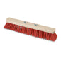 The Nölle Profi Brush hall broom Elaston with wing screws from Nölle Profi Brush Bürsten- & Pinseltechnik e.K. is characterized by a light wooden block, dense red Elaston bristles, and two metal wing screws for easy handle attachment.